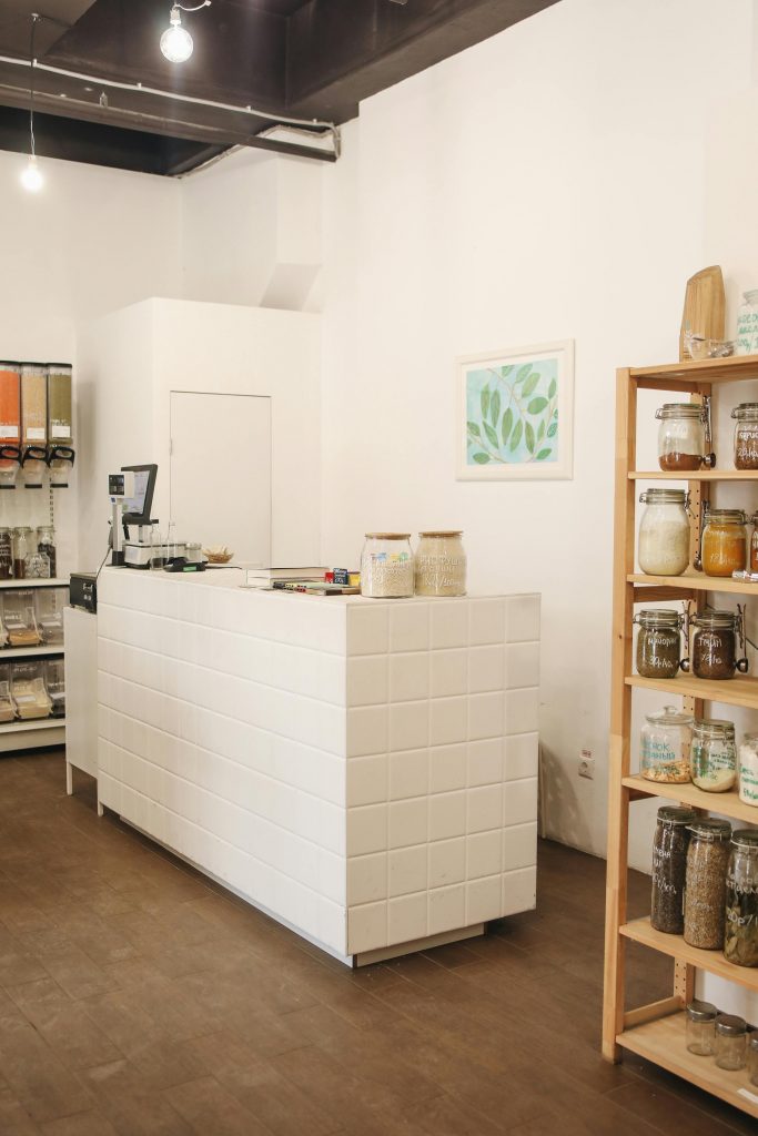 pexels-photo-3735185-3735185 Bright minimalistic zero waste store interior with wooden shelves and sustainable products displayed.